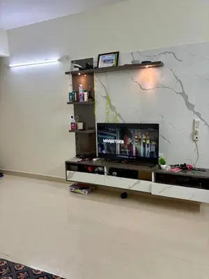 a living room with a flat screen tv on a wall at Hazel's ELiTE Homestay 3BHK in Mysore