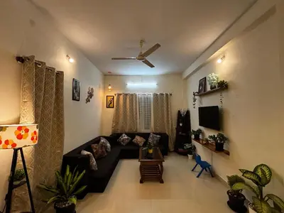 a living room with a couch and a tv at Hazel's ELiTE Homestay 2bhk in Mysore