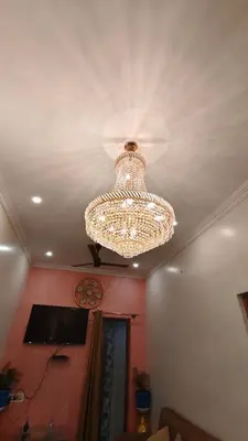 a chandelier hanging from a ceiling in a room at Steeva Guest house in Mysore