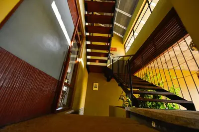 a hallway with a staircase in a building at Homestay Namaha in Meppādi