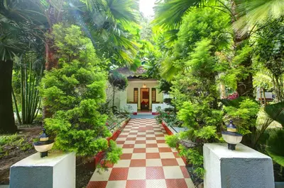 a garden with a red and white checkered walkway at Gokulam Grand Resort & Spa, Coorg in Kushālnagar