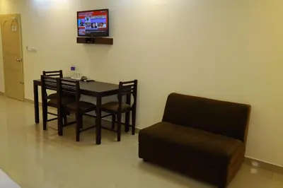 a dining room with a table and a chair at Anna Residency in Nedumbassery