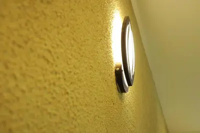 a close up of a yellow wall with a screw at Anna Residency in Nedumbassery