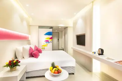 a hotel room with a bed and a bowl of fruit on a table at ZIBE Coimbatore by GRT Hotels in Coimbatore