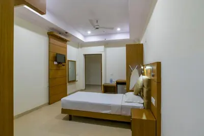a bedroom with a bed and a television in it at Sree Gokulam Residency in Trichūr