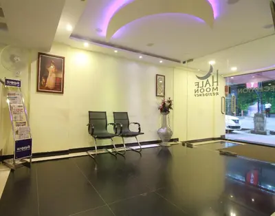 a lobby with two chairs in a building at Half Moon Residency Calicut in Kozhikode