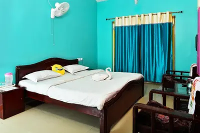 a bedroom with a bed with two stuffed animals on it at RK Holiday Home in Ooty
