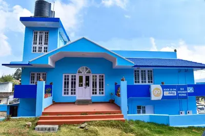 a blue house with a water tower at RK Holiday Home in Ooty