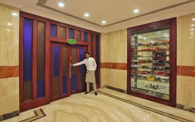 a man standing in front of a door with a frisbee at Seashore Residency in Kodungallūr