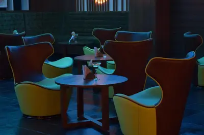 a row of tables and chairs in a restaurant at Kiscol Grands Hotel in Coimbatore