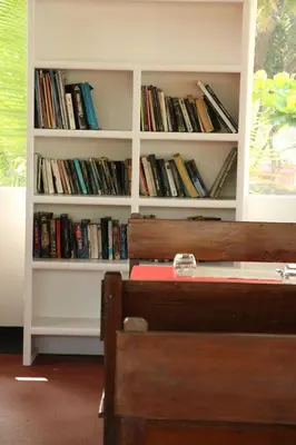a book shelf filled with lots of books at Petit Elephant in Cherai Beach