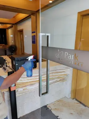 a person is painting a sign in a building at Hotel Park Residency Calicut in Kozhikode