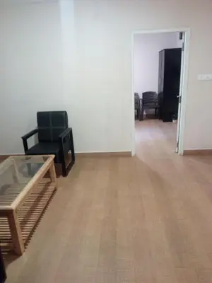 an empty living room with a table and chairs at The Hill Side in Ooty