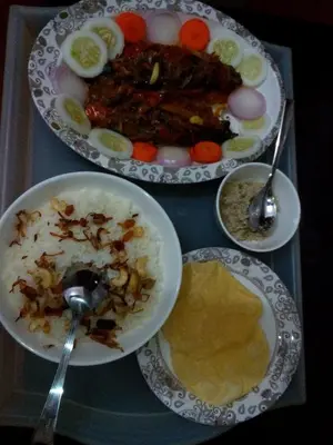 a tray with three plates of food on a table at Ivory Coaste in Kannur