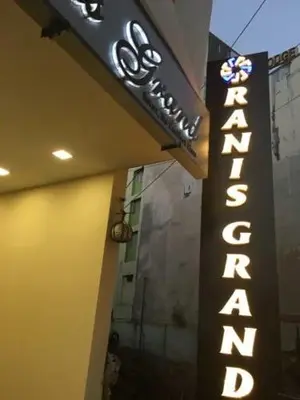 a sign for a restaurant on the side of a building at Ranis Grand in Coimbatore