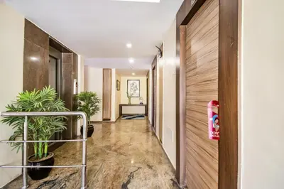 an office corridor with plants in a hallway at FabHotel Jansi Deluxe - Nr Gandhipuram Bus stand in Coimbatore
