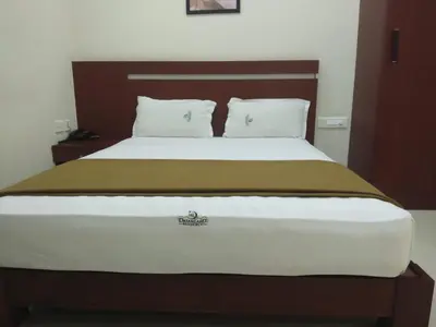 a large bed with two pillows on top of it at Dream Land Residency in Mananthavady