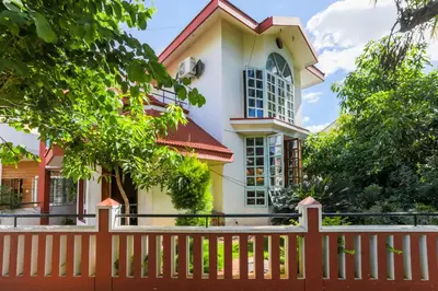a house with a fence in front of it at LikeMyHome Homestay Mysore in Mysore