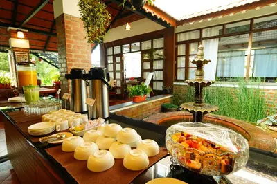 a buffet of food on a table in a restaurant at Mount Xanadu Resorts in Ambalavayal