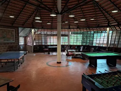 a large room with ping pong tables in it at Misty Woods Resort in Kakkabe