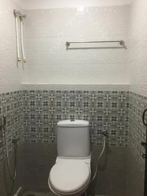 a bathroom with a white toilet in a room at Kvm Tourist Home in Palakkad