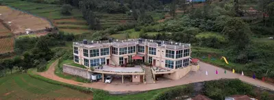 an aerial view of a large house in a field at Tulips Valley View Resorts in Ooty