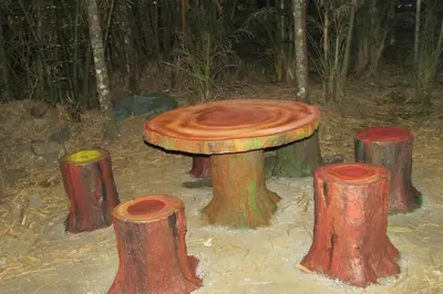 a painting of a tree stump table in the woods at Greenwoods Nature Camp in Mudumalai National Park