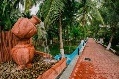 a water fountain in a park with palm trees at Sterling Anaikatti in Varagampadi