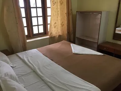 a bed in a bedroom with a window at Green Acres Farm Guest House in Masinagudi