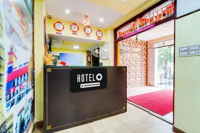 a hotel entrance with a sign in a room at Super Hotel O Airport Road Coimbatore in Coimbatore
