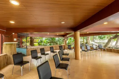 a conference room with chairs and a bar at KSTDC Hotel Mayura Riverview Srirangapatna in Seringapatam