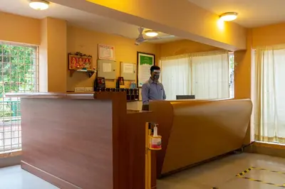 a man standing at a counter in a restaurant at KSTDC Hotel Mayura Sangama Mekedatu in Mulhalli