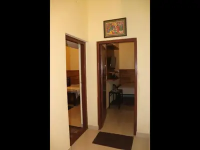 a hallway with a mirror and a room at Coorg North Breeze Homestay in Madikeri