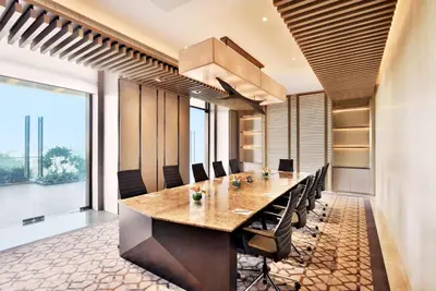 a conference room with a long table and chairs at Radisson Blu Coimbatore in Coimbatore
