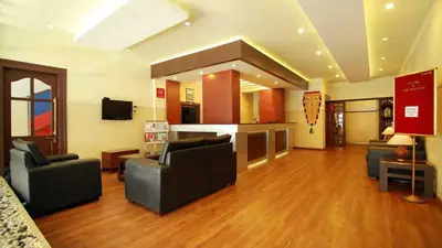 a large living room with couches and a television at Hotel Palace Tower in Trichūr