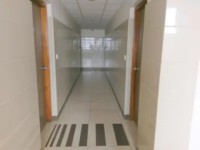 a hallway of an office building with a hallway of glass doors at Banyan Tree Comforts Mysore in Mysore