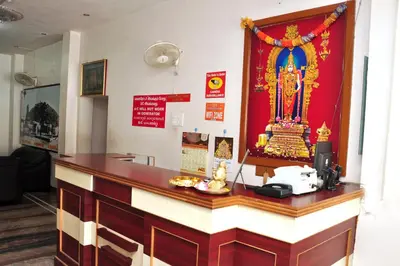 a bar in a room with a red wall at Arunaachalaa Inn in Palani