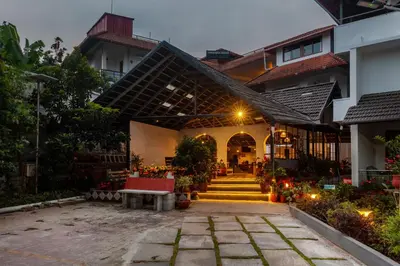 a courtyard of a house with stairs and flowers at Treebo Vrindavan, 3 Km From Madikeri Fort in Madikeri