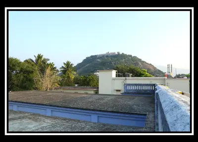 a blue bench sitting on top of a roof at Pattiah Naidu Palace in Palani