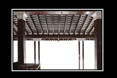 a window with a wooden blind on top of it at Pattiah Naidu Palace in Palani