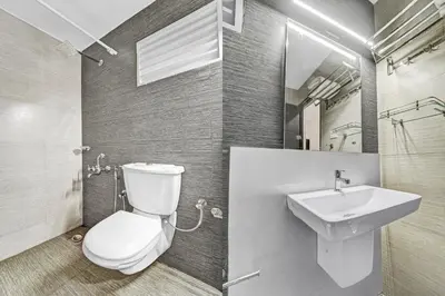 a bathroom with a toilet and a sink at Collection O Kalady Near Airport in Cochin