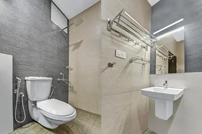 a bathroom with a toilet and a sink at Collection O Kalady Near Airport in Cochin