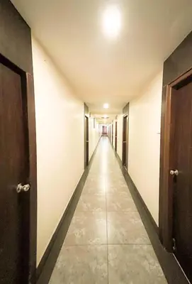 an empty corridor in a building with a long hallway at Shree Residency in Erode