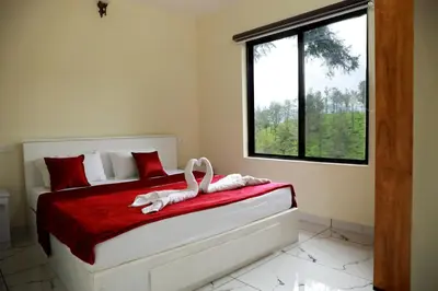 a bedroom with a bed with two swans on it at Green Garden Jasmin Cottage in Vayittiri