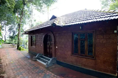 a small brick building with a window on a sidewalk at Green Garden Jasmin Cottage in Vayittiri