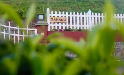a white fence with a sign that says karamobi at The Xanadu, Coonoor in Coonoor