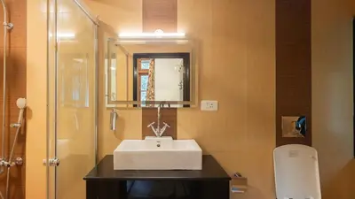 a bathroom with a sink and a shower at SaffronStays Milton Abbott Estate - 2BR colonial-era bungalow with garden, golf course views & bonfire nights near Ooty Golf Club in Ooty