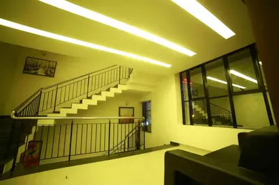 a hallway with a spiral staircase in a building at Nalanda Inn in Palakkad