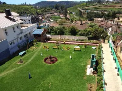 an aerial view of a yard with a playground at Drizzle Drop Inn in Ooty