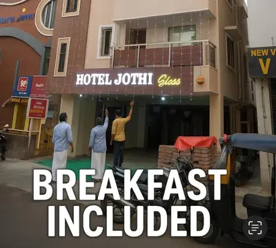a group of people standing outside of a building at Hotel Jothi in Coimbatore